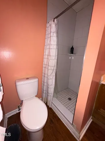 a bathroom with a toilet and a shower