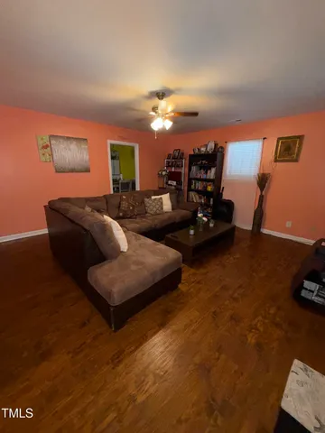 a living room with furniture and wooden floor