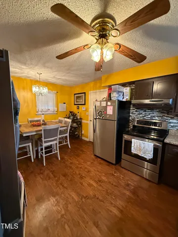a view of a kitchen with a microwave and furniture