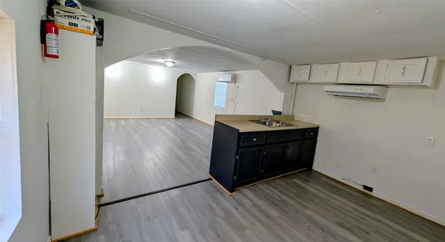 a kitchen with stainless steel appliances granite countertop a sink and a refrigerator