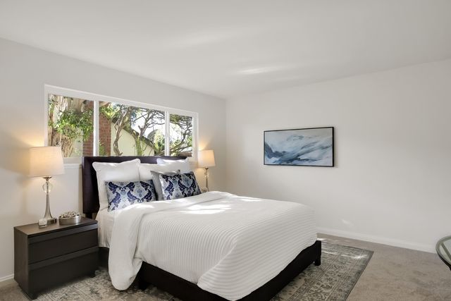 a bed sitting in a bedroom next to a window