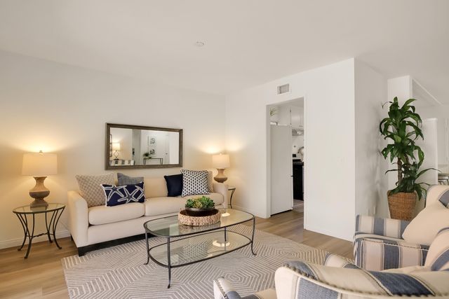 a living room with furniture and a potted plant