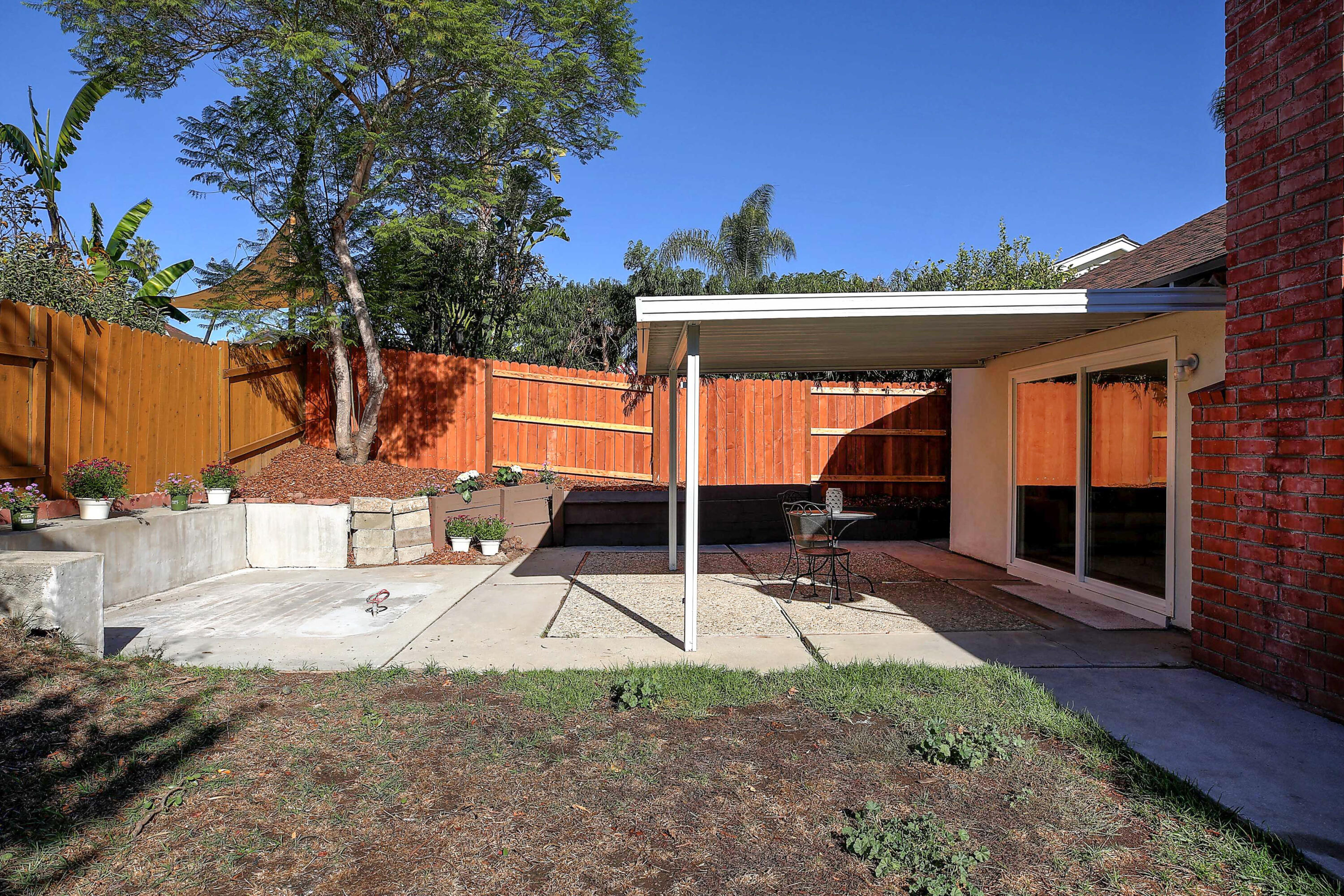 249 Placer Drive Santa Barbara, CA 93117 - Photo 26 of 33 a view of a patio with table and chairs a barbeque with wooden fence and floor