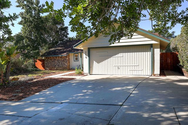 a view of a house with a flower garden
