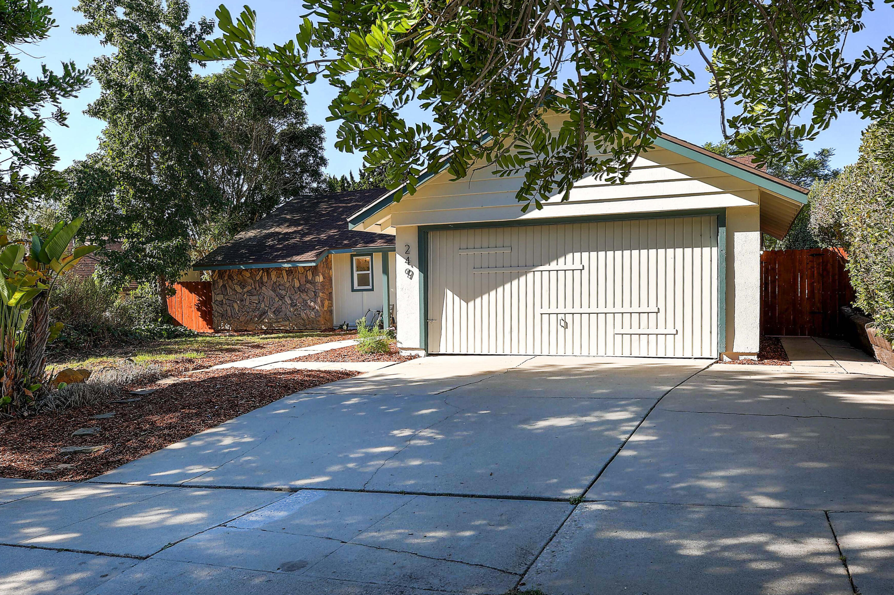 249 Placer Drive Santa Barbara, CA 93117 - Photo 31 of 33 a front view of a house with a yard and garage