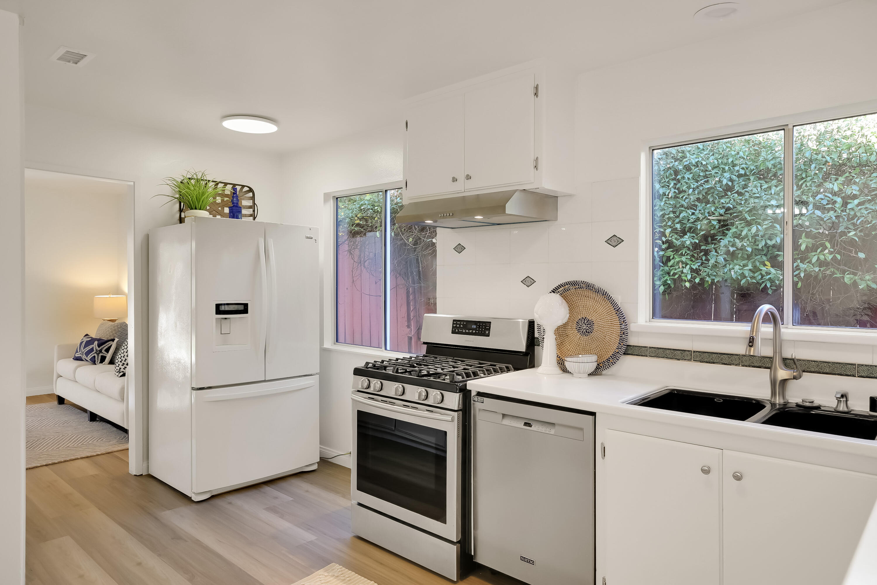 249 Placer Drive Santa Barbara, CA 93117 - Photo 6 of 33 a kitchen with stainless steel appliances granite countertop white cabinets and a window