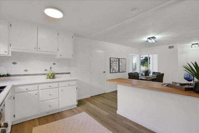 a kitchen with granite countertop a sink and cabinets