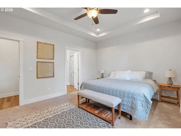 a bedroom with a bed chandelier and window
