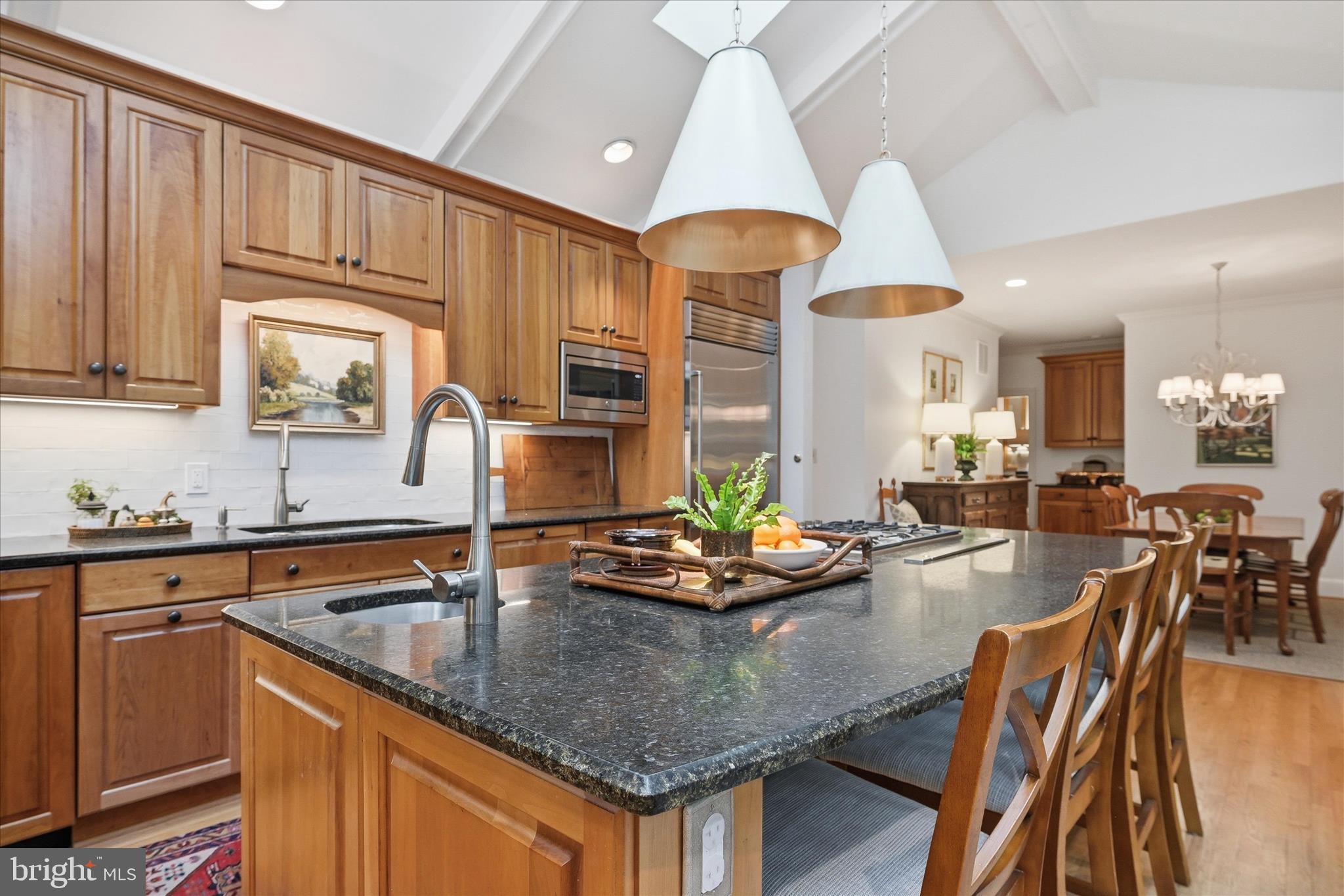3824 Military Road Arlington, VA 22207 - Photo 9 of 54 a kitchen with granite countertop a stove a sink a dining table and chairs