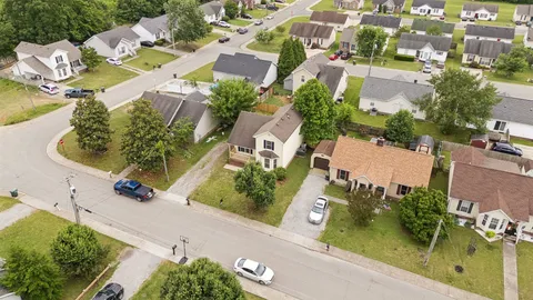 an aerial view of residential houses with outdoor space