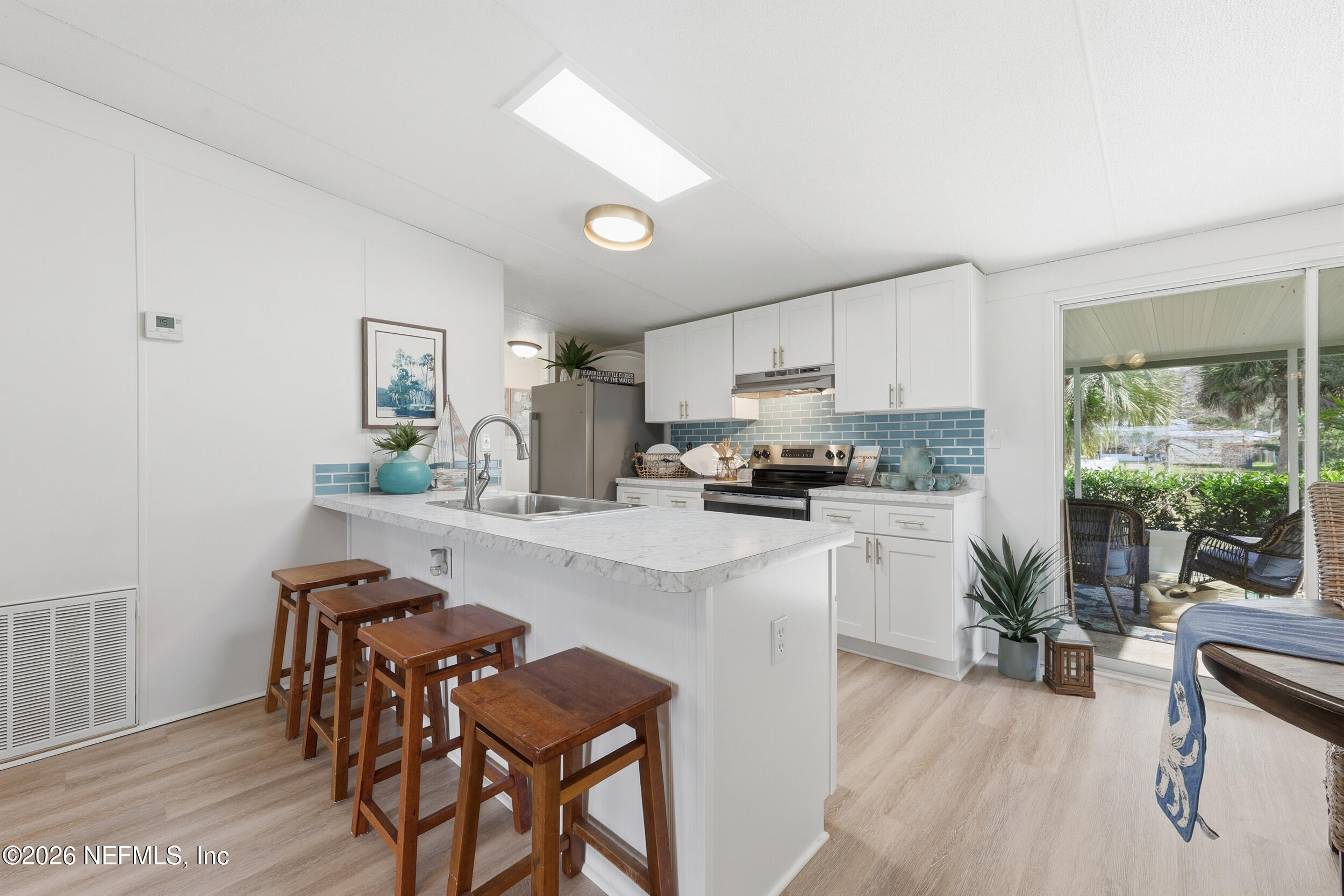 116 Waterside Avenue Satsuma, FL 32189 - Photo 14 of 53 a kitchen with white cabinets and stainless steel appliances
