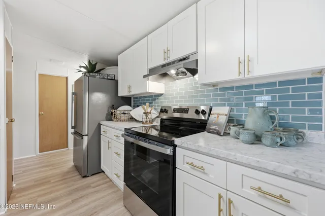 a view with a sink and mirror with wooden floor