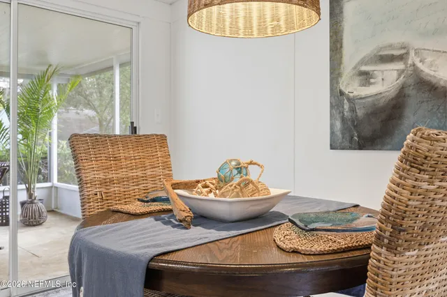 a living room with furniture a table and wooden floor