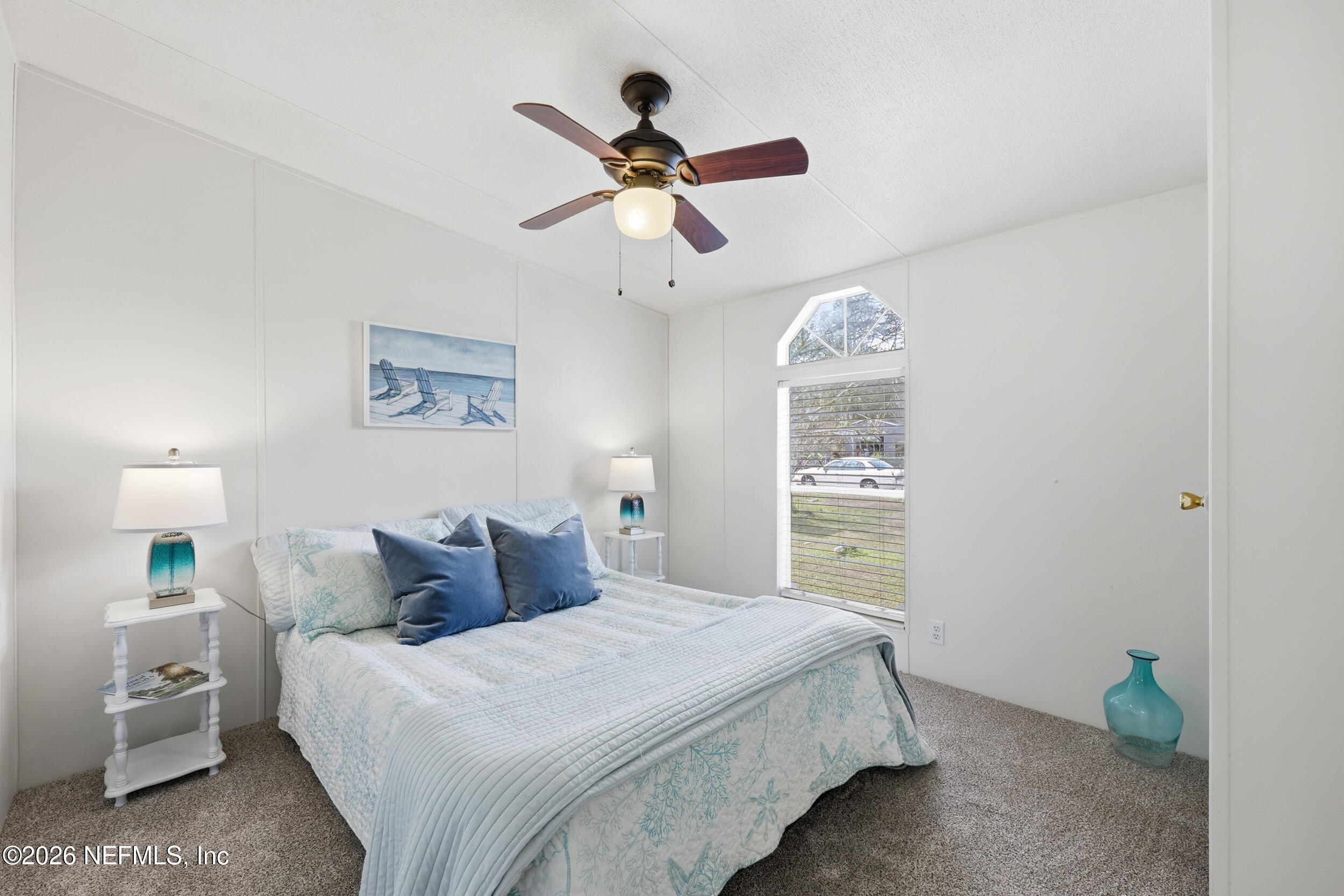 116 Waterside Avenue Satsuma, FL 32189 - Photo 28 of 53 a bedroom with a bed and a chandelier