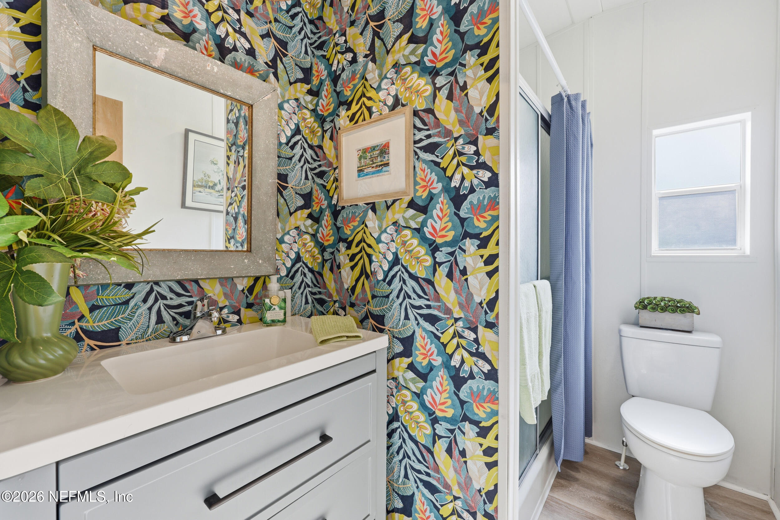 116 Waterside Avenue Satsuma, FL 32189 - Photo 30 of 53 a bathroom with a sink a toilet and shower curtain