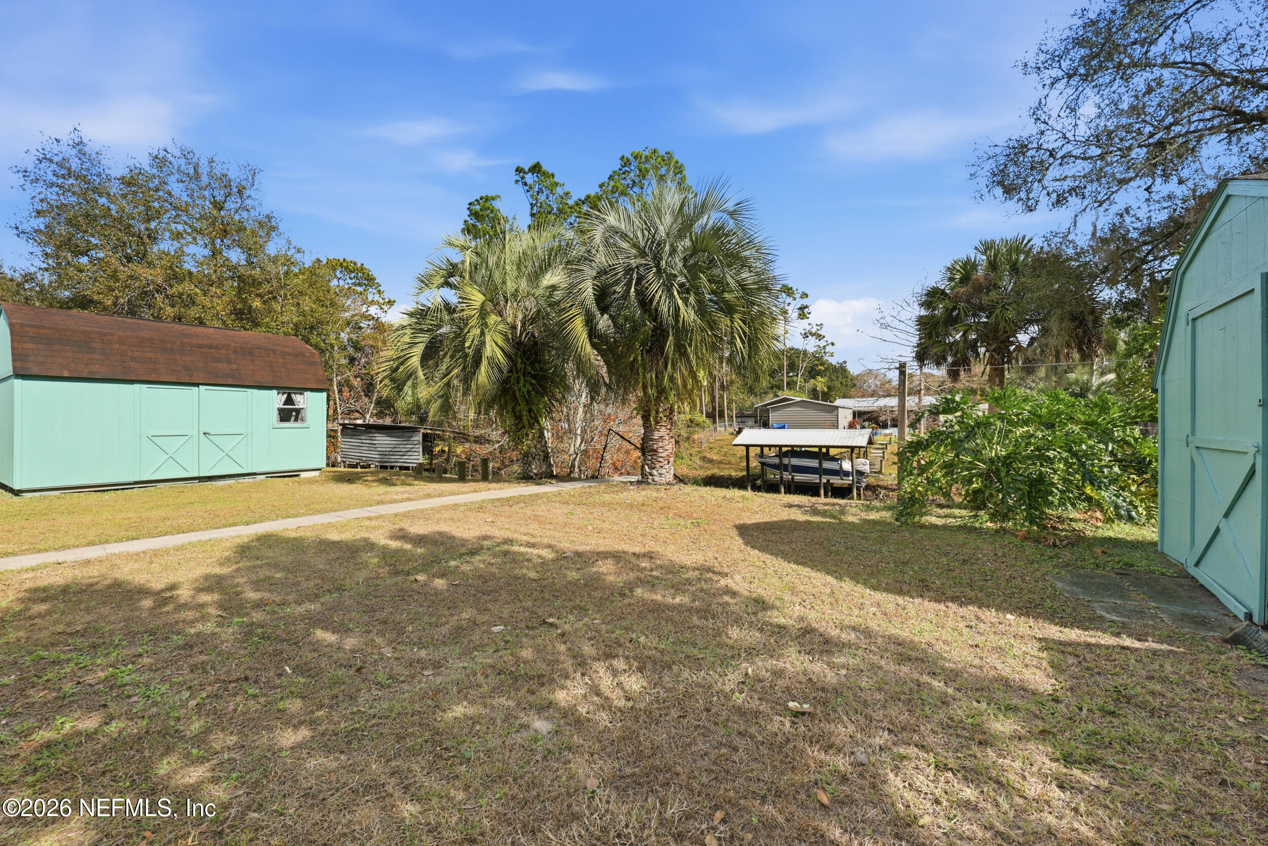 116 Waterside Avenue Satsuma, FL 32189 - Photo 41 of 53 a palm tree sitting in front of a building with trees
