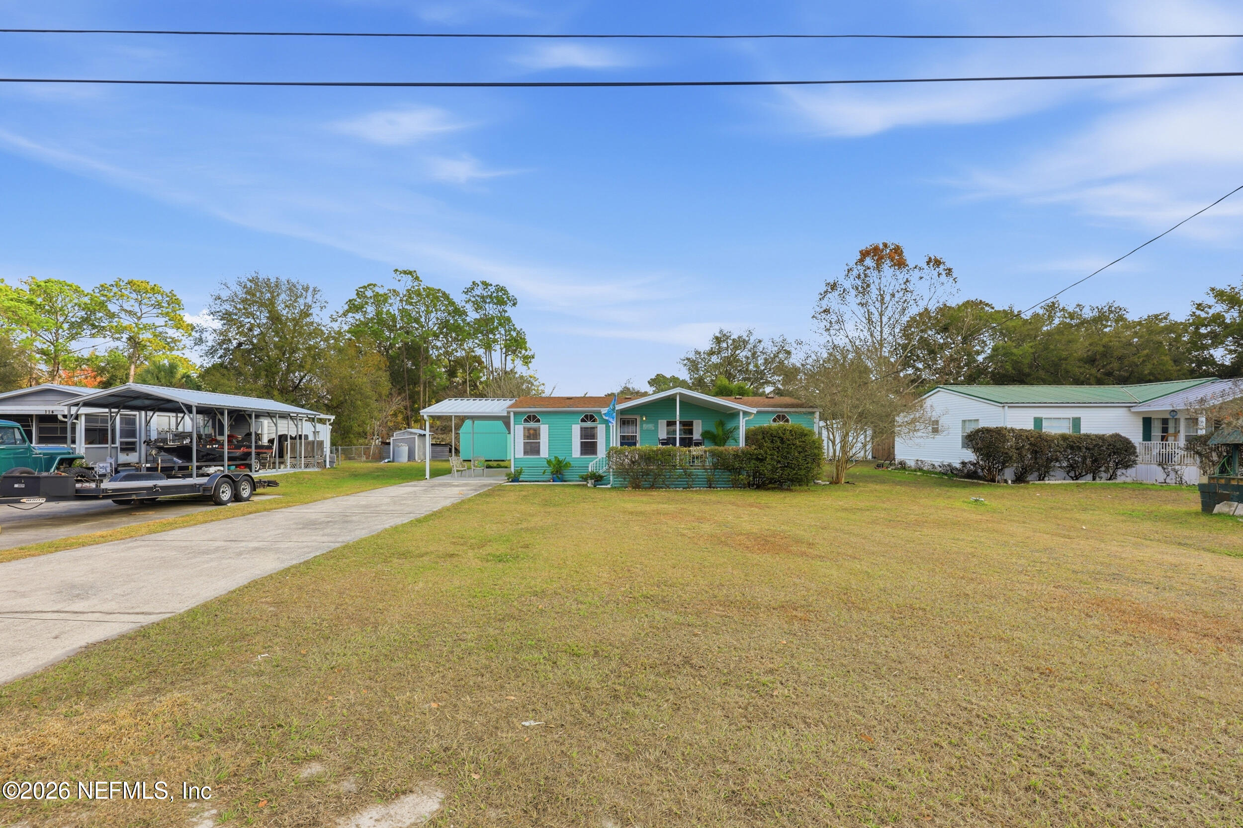 116 Waterside Avenue Satsuma, FL 32189 - Photo 52 of 53 a front view of a house with a garden and yard