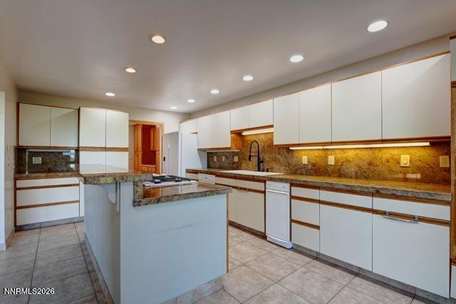 2640 Rockview Drive Reno, NV 89519 - Photo 26 of 56 a kitchen with stainless steel appliances granite countertop a stove top oven a sink and white cabinets
