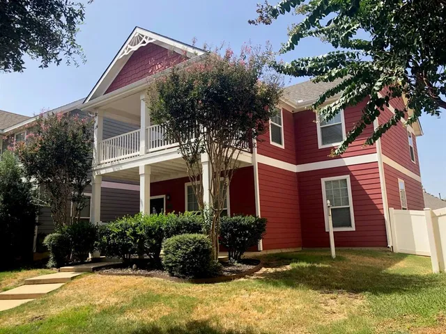 a house that has a tree in front of the house
