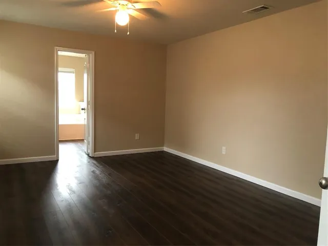 a view of an empty room and wooden floor