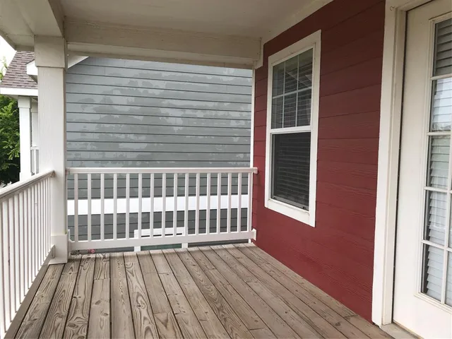 a view of a deck with wooden floor and fence