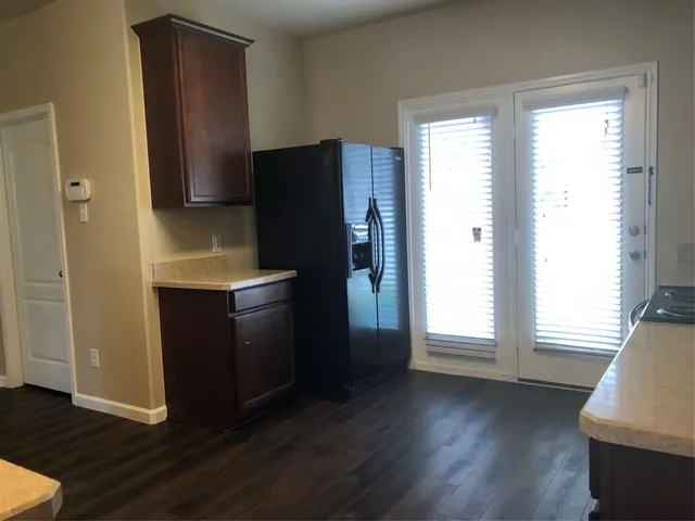 a kitchen with a refrigerator and window