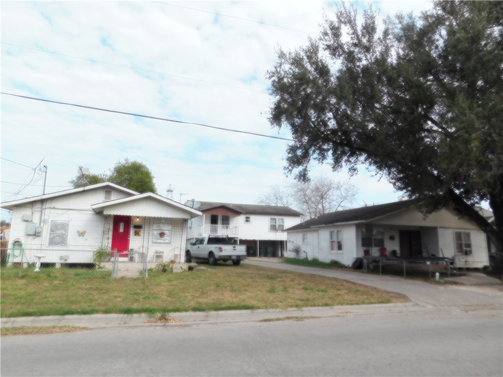 409 Chaparral Street Alice, TX 78332 - Photo 1 of 24 a front view of a house with a yard and garage