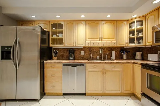 a kitchen with a sink a stove and cabinets