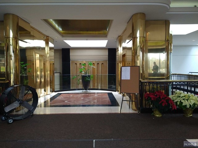 a lobby with furniture and floor to ceiling window