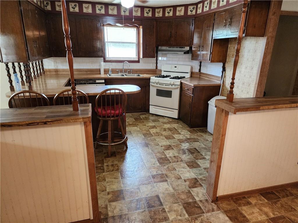 4706 Iowa Street Waco, TX 76705 - Photo 13 of 21 a kitchen with stainless steel appliances granite countertop a sink stove and refrigerator