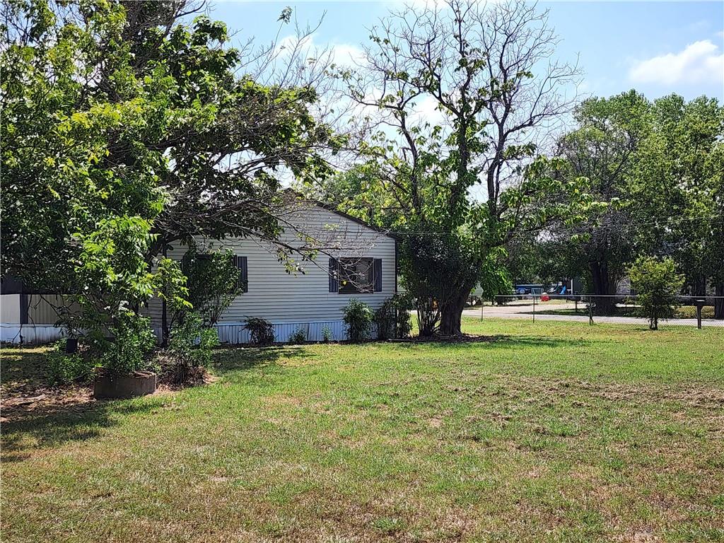 4706 Iowa Street Waco, TX 76705 - Photo 2 of 21 a view of a house with a big yard and large trees