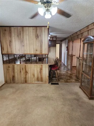 a view of a room with furniture and a chandelier