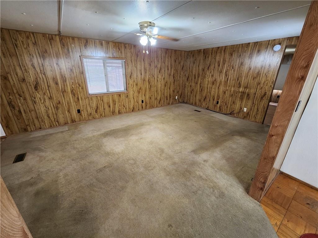 4706 Iowa Street Waco, TX 76705 - Photo 10 of 21 an empty room with a chandelier fan and windows
