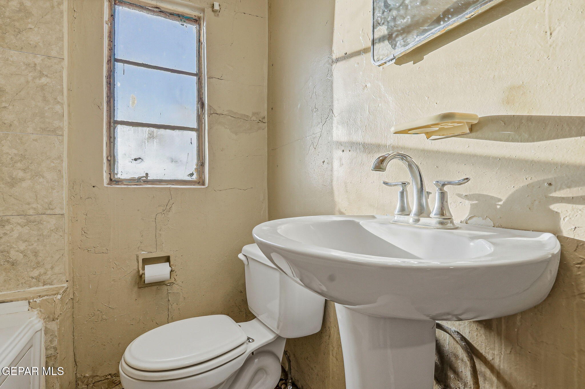 116 Tamarisk Street Anthony, TX 79821 - Photo 13 of 36 a bathroom with a sink a toilet and mirror