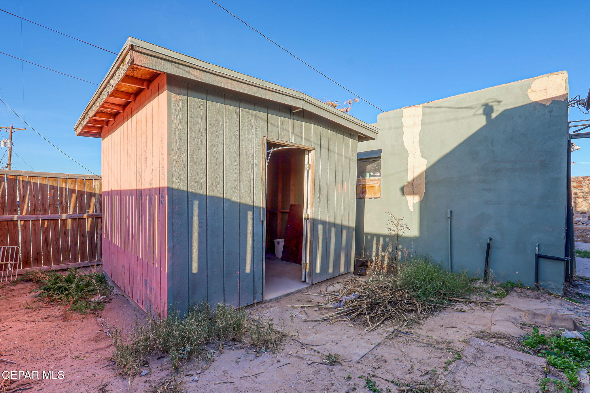116 Tamarisk Street Anthony, TX 79821 - Photo 23 of 36 a backyard of a house with plants and wooden fence
