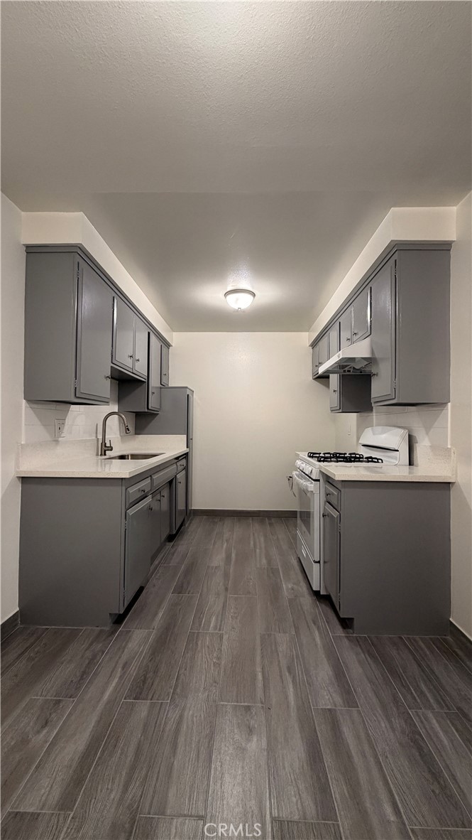 908 Marguerita Avenue, Unit 1 Alhambra, CA 91803 - Photo 2 of 11 a kitchen with stainless steel appliances granite countertop a stove a sink dishwasher and a refrigerator with wooden floor