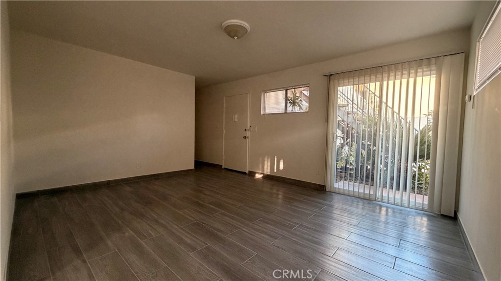 908 Marguerita Avenue, Unit 1 Alhambra, CA 91803 - Photo 3 of 11 a view of an empty room with wooden floor and a window