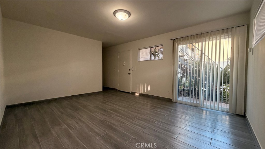 908 Marguerita Avenue, Unit 1 Alhambra, CA 91803 - Photo 4 of 11 an empty room with wooden floor and windows