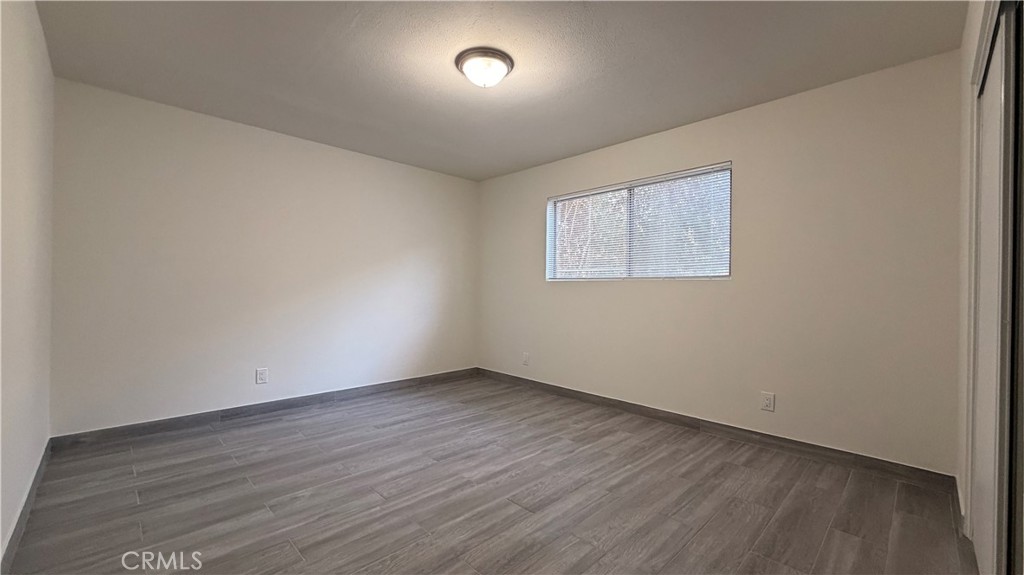 908 Marguerita Avenue, Unit 1 Alhambra, CA 91803 - Photo 7 of 11 an empty room with wooden floor and windows