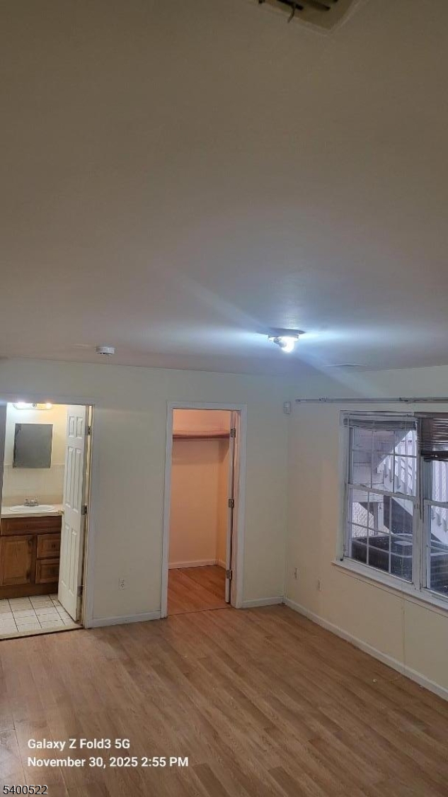 306 1st Street, Unit 1 Elizabeth Port, NJ 07206 - Photo 15 of 23 an empty room with wooden floor and windows