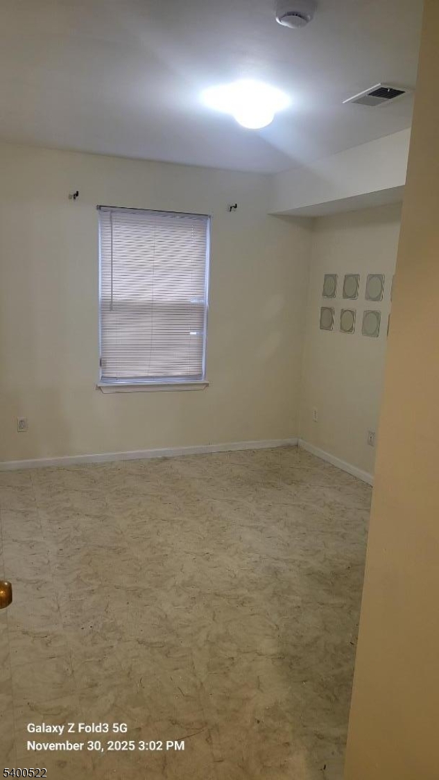 306 1st Street, Unit 1 Elizabeth Port, NJ 07206 - Photo 18 of 23 an empty room with a empty space and windows