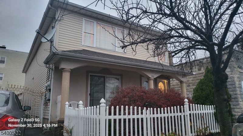 306 1st Street, Unit 1 Elizabeth Port, NJ 07206 - Photo 21 of 23 a front view of a house with a tree