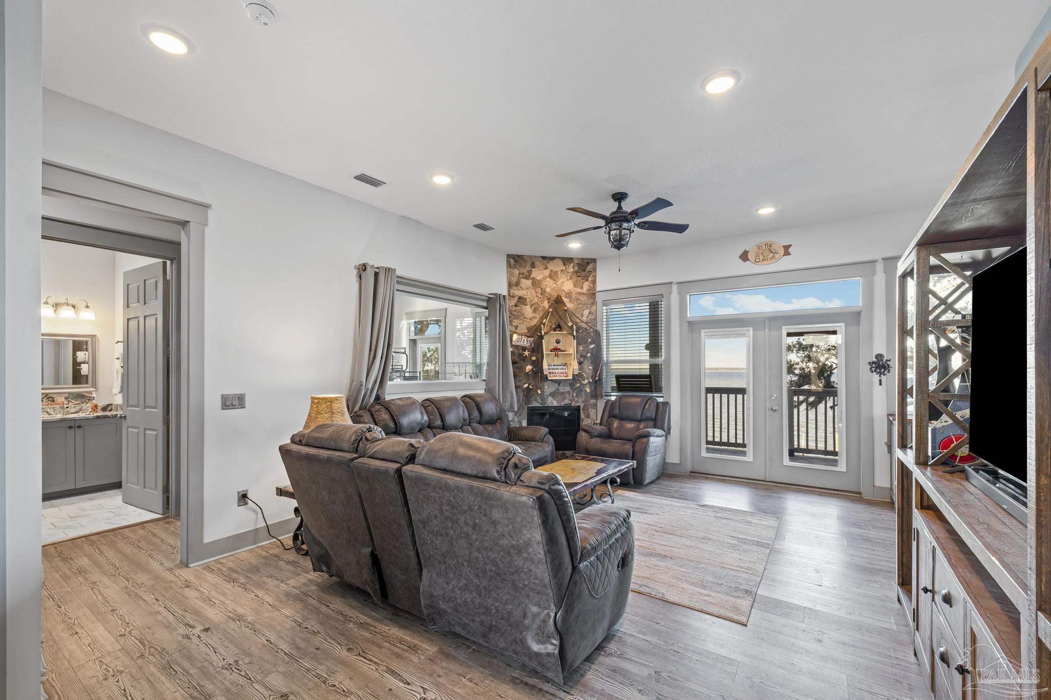 305 Garcon Point Road Milton, FL 32583 - Photo 13 of 72 a living room with furniture and a flat screen tv