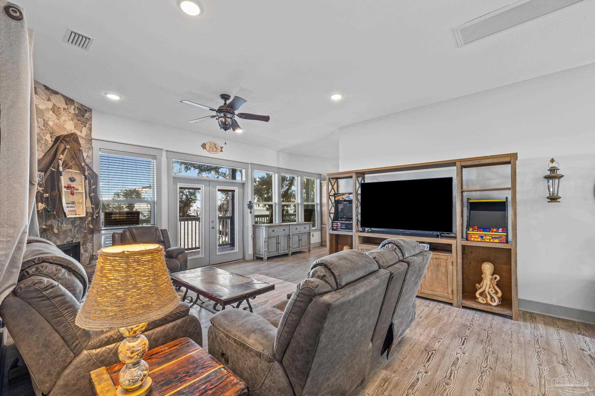 305 Garcon Point Road Milton, FL 32583 - Photo 14 of 72 a living room with furniture and a flat screen tv
