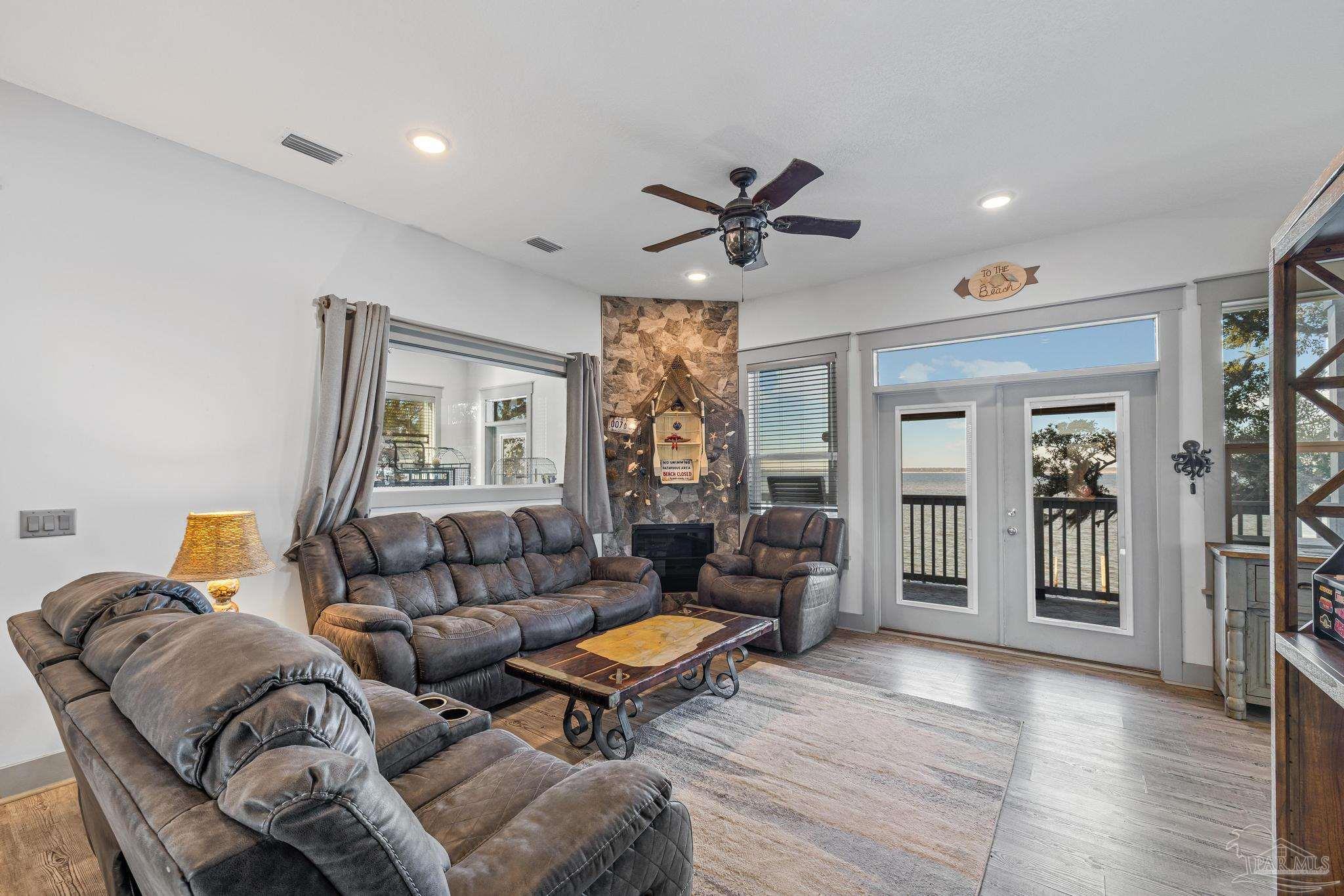 305 Garcon Point Road Milton, FL 32583 - Photo 15 of 72 a living room with furniture and wooden floor