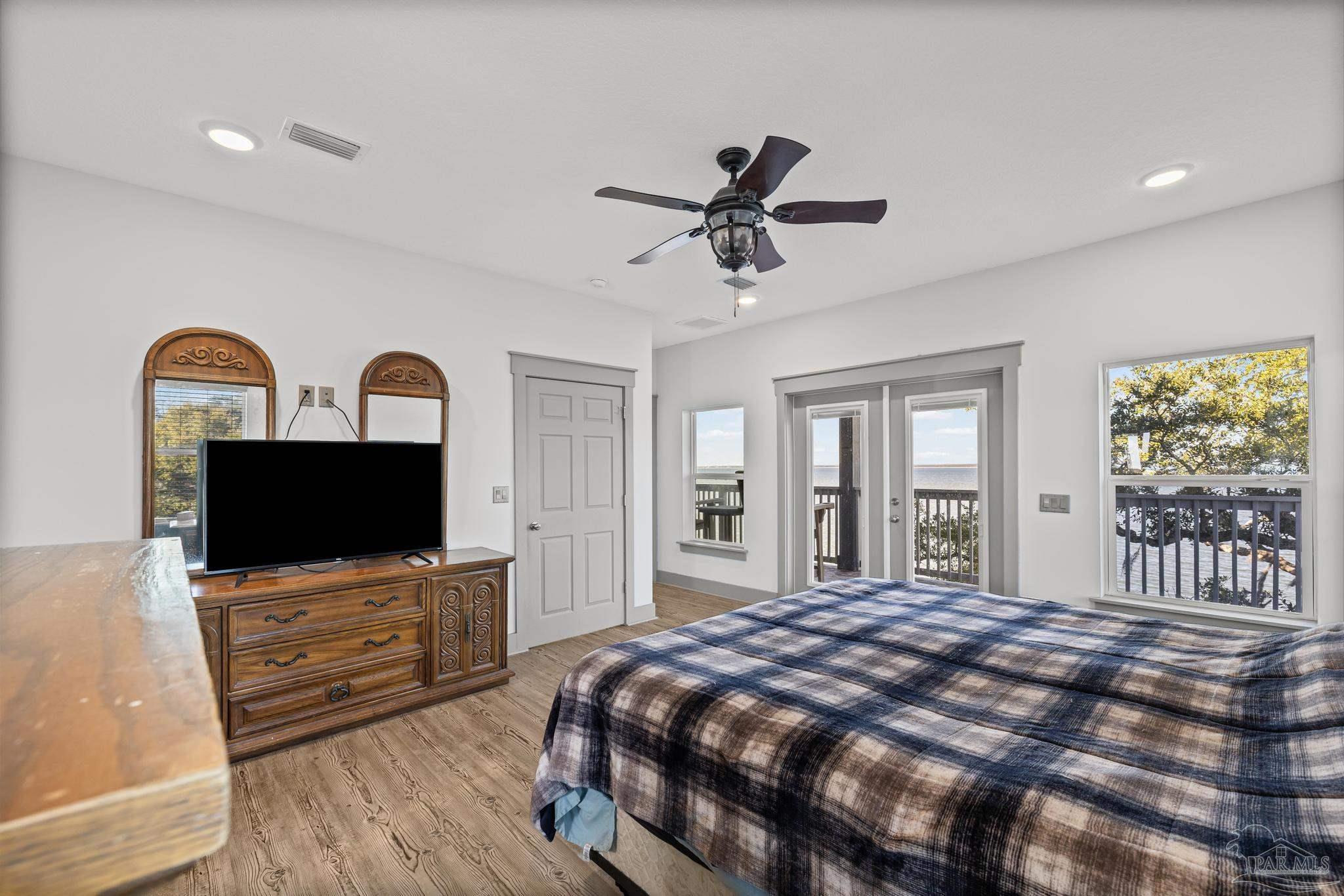 305 Garcon Point Road Milton, FL 32583 - Photo 33 of 72 a bedroom with a bed and a flat screen tv