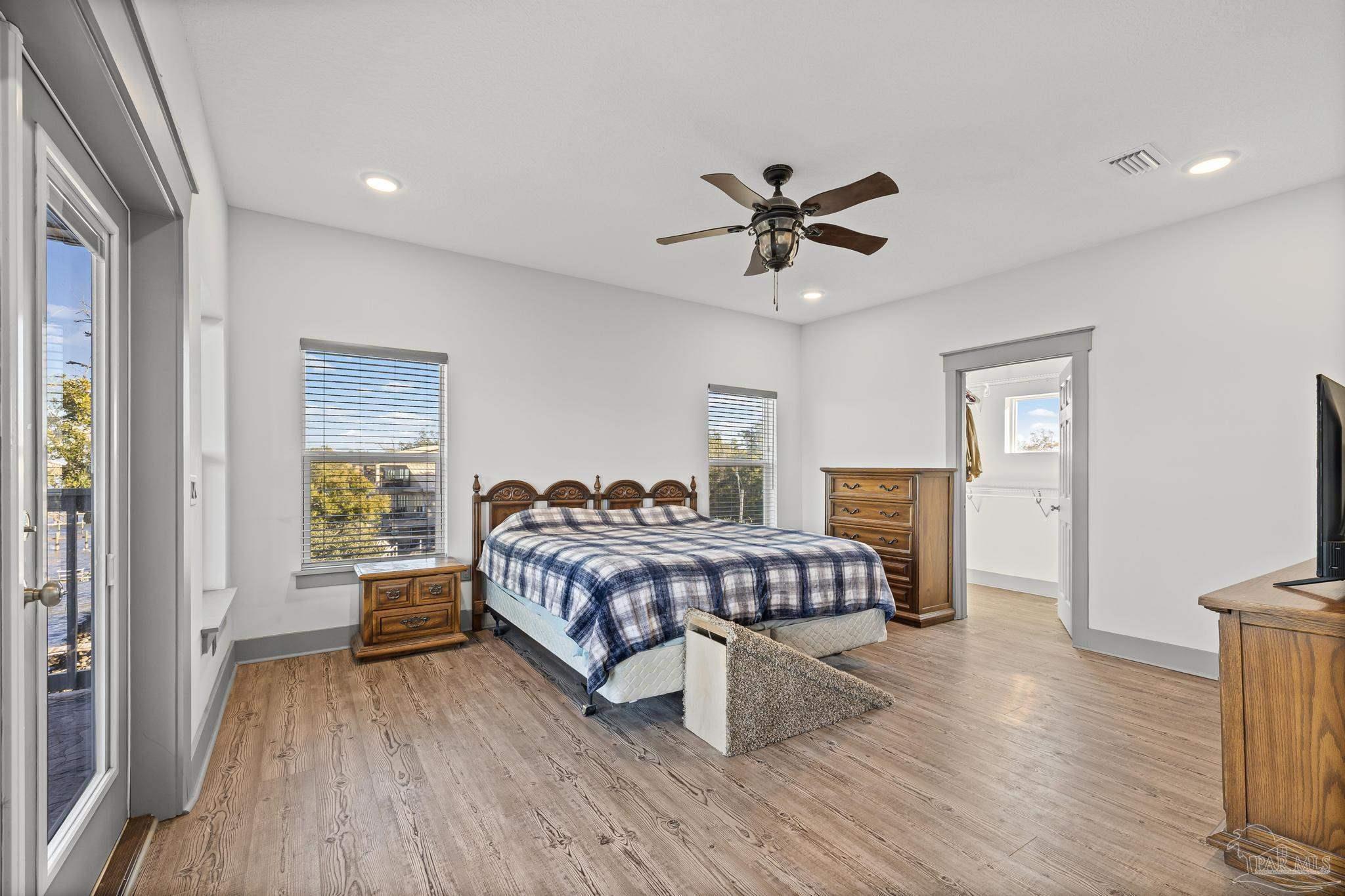 305 Garcon Point Road Milton, FL 32583 - Photo 34 of 72 a bedroom with a bed and a chandelier