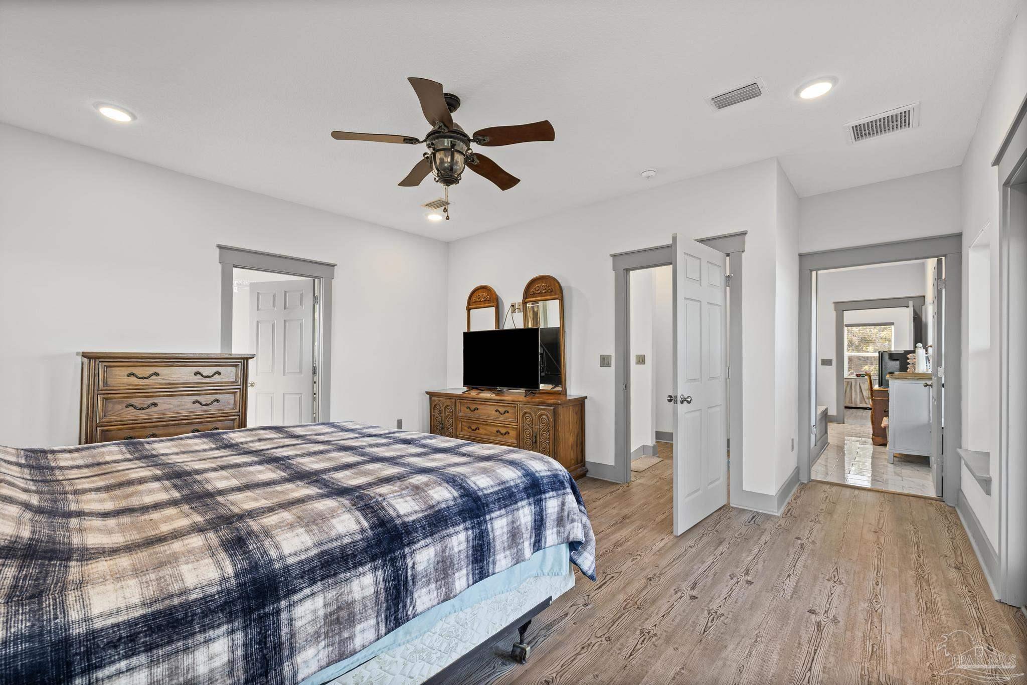 305 Garcon Point Road Milton, FL 32583 - Photo 35 of 72 a bedroom with a bed and a dresser