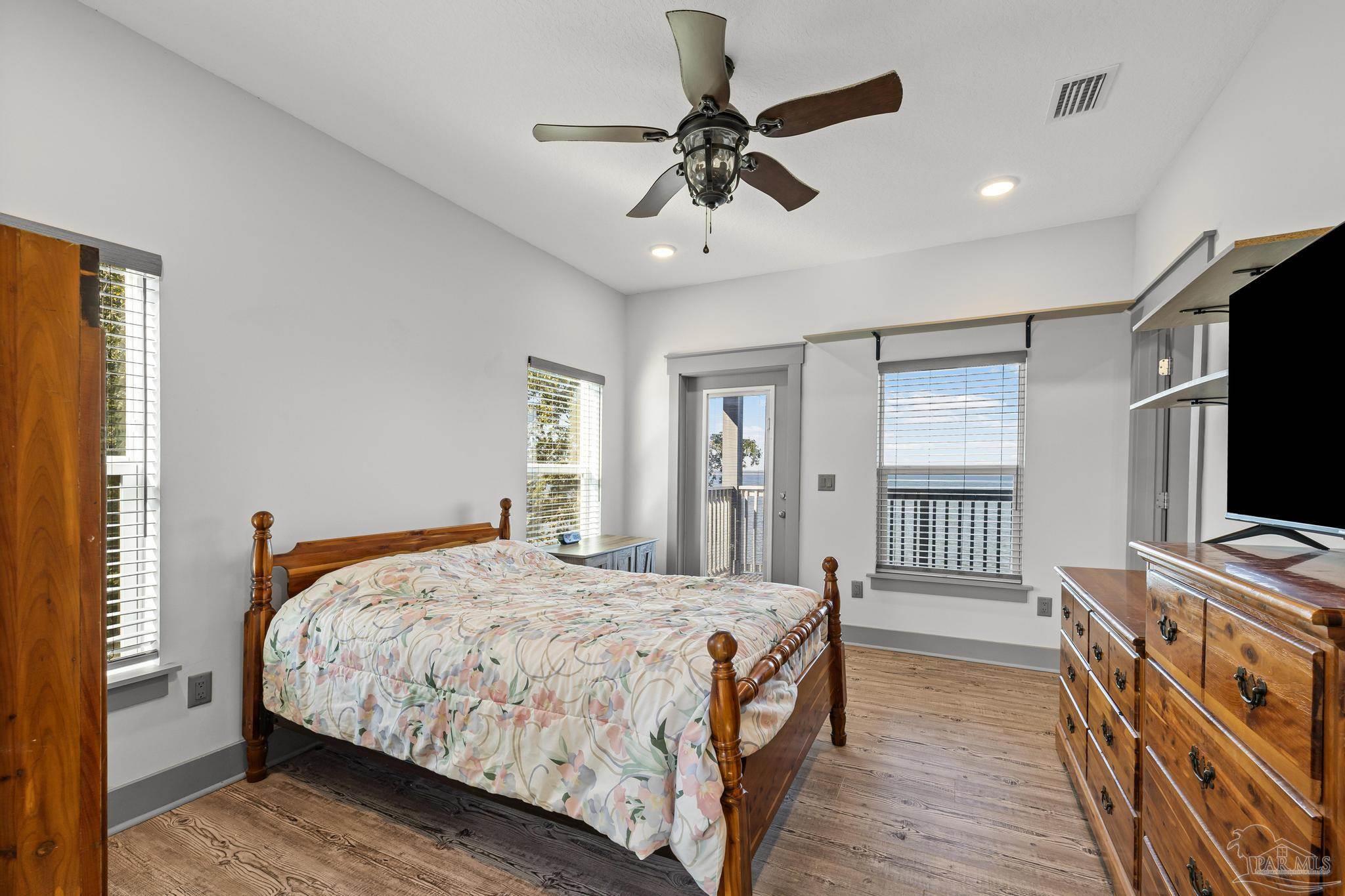 305 Garcon Point Road Milton, FL 32583 - Photo 37 of 72 a bedroom with a bed and a flat screen tv
