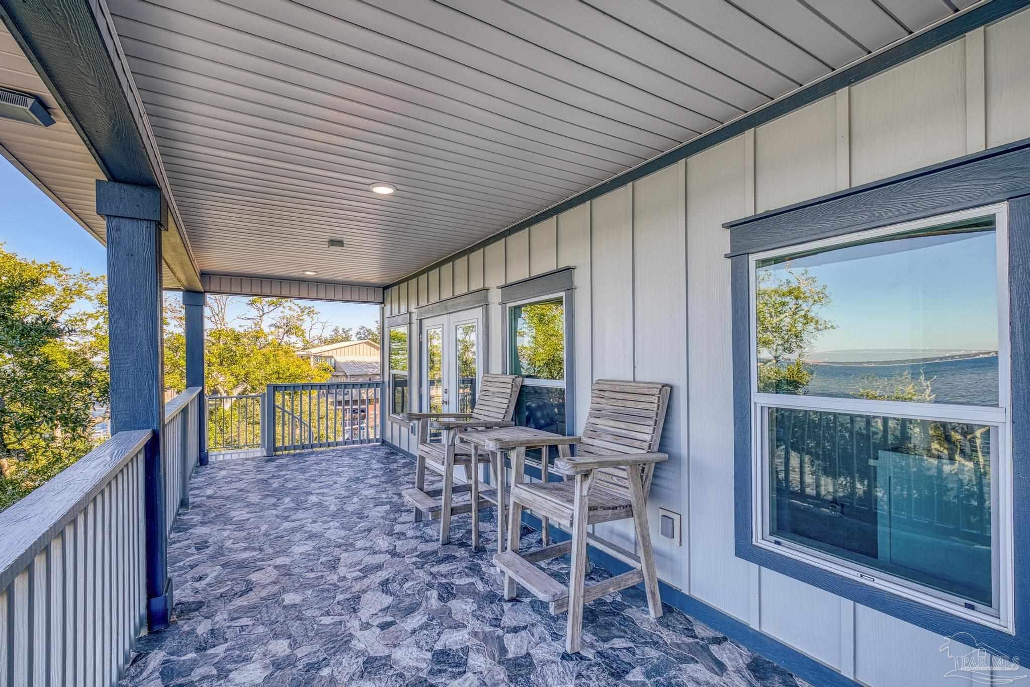 305 Garcon Point Road Milton, FL 32583 - Photo 46 of 72 a view of a porch with chairs and backyard